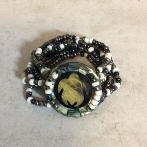 Multi strand bead stretch bracelet with abalone turtle faceplate